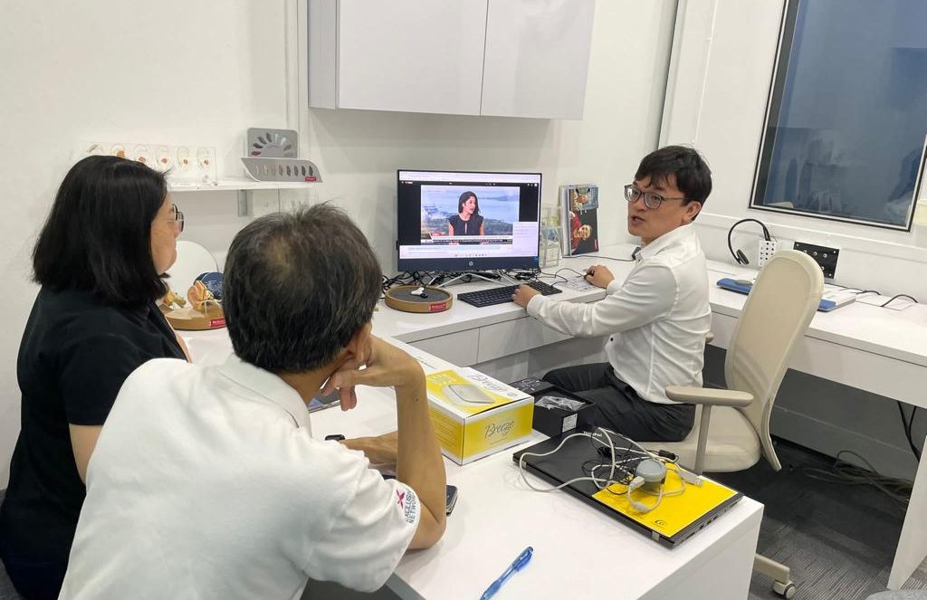 Mr Alan Chang Amazing Hearing audiologist with patients in clinic session